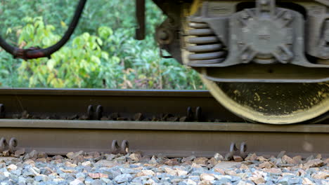 passing wheels of cargo train, railroad transportation, track with railway car or wagon