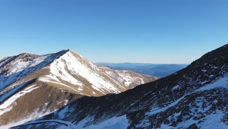 aerial view raising shot flight over majestic snow mountain landscape at winter season