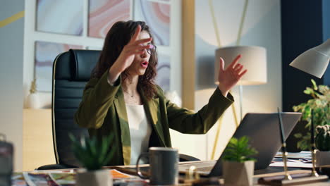 business woman arguing video call at office desk close up. boss throwing papers