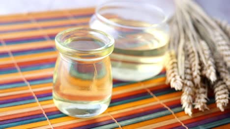 wheat germ oil in glass bottles with wheat ears