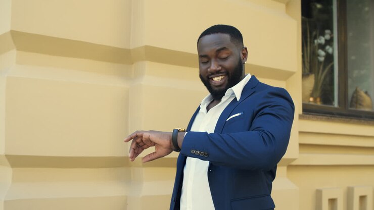 Happy businessman walking on urban street