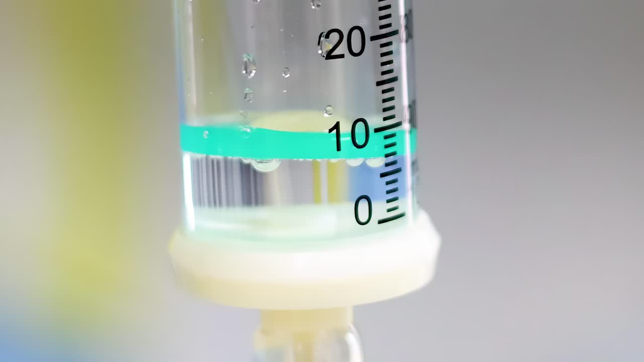 A detailed view of a liquid level in a transparent graduated cylinder with measurement markings.