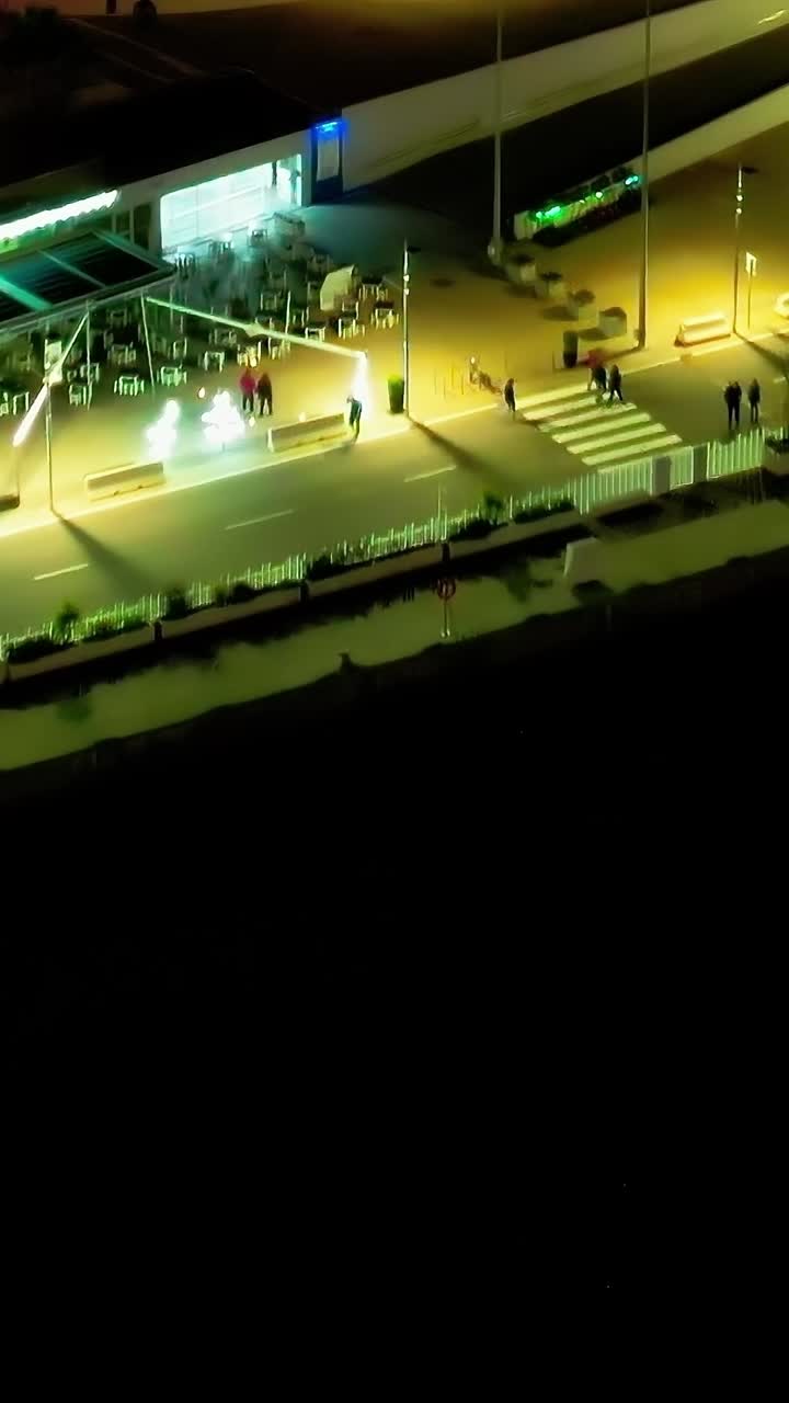 Night view of the waterfront in Malaga Spain with lively activities