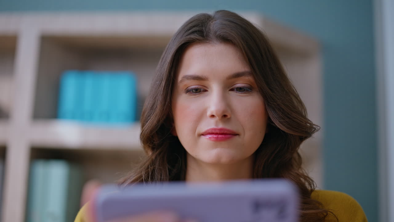 Lady watching horizontal mobile phone at office interior closeup. Relaxed woman