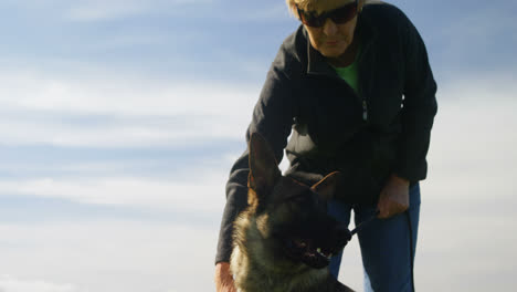 Shepherd-dog-standing-with-his-owner-in-the-farm-4k