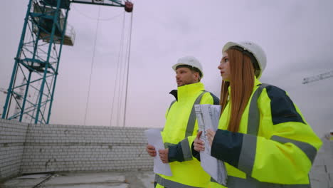 Una-Joven-Ingeniera-Civil-Y-Capataz-Caminan-En-Obras-De-Construcción-Especialistas-En-Construcción.