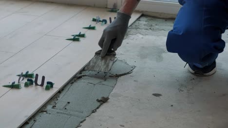 construction, renovation, repair apartment. installing ceramic floor tiles - measuring and cutting the pieces. cuts tile. tile cutting