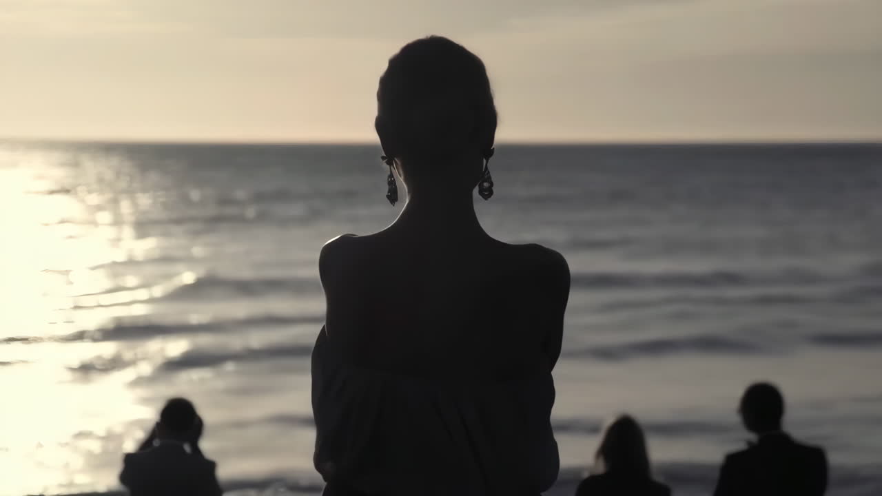 Silhouettes of People Watching the Ocean at Sunset