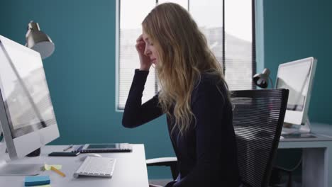 Caucasian-woman-tired-at-the-office