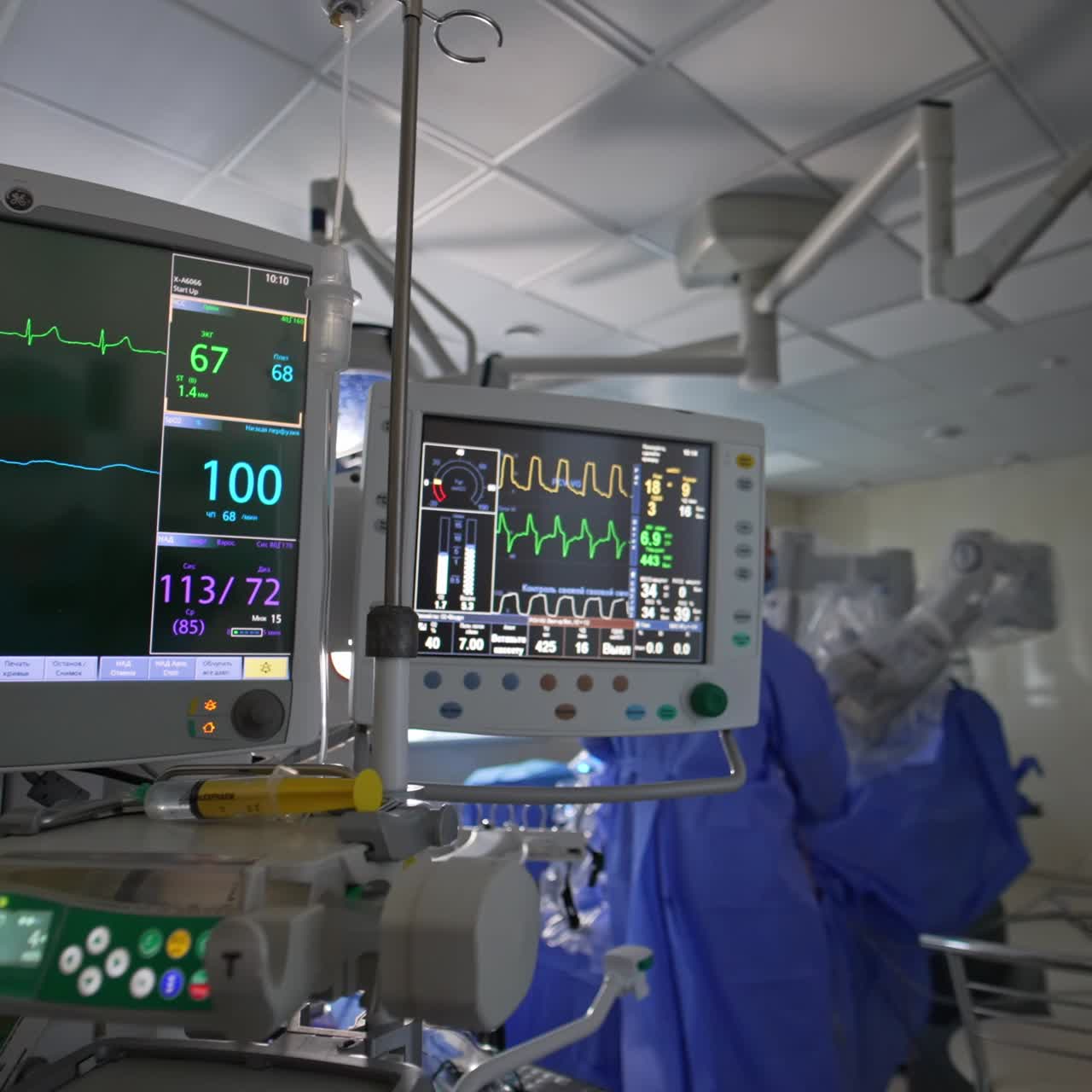 Modern advanced equipment working in the operational theatre during surgery. Screens working at backdrop and foreground of operational room
