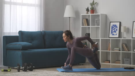 young-sporty-woman-is-practicing-yoga-at-home-doing-asana-for-stretching-body-workout-at-weekend-at-self-isolation-and-lockdown-training-in-living-room