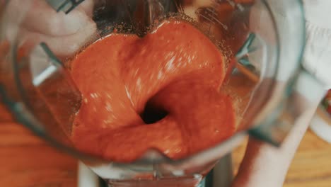 grinding spices and veggies in a compact grinder for red bell pepper sauce