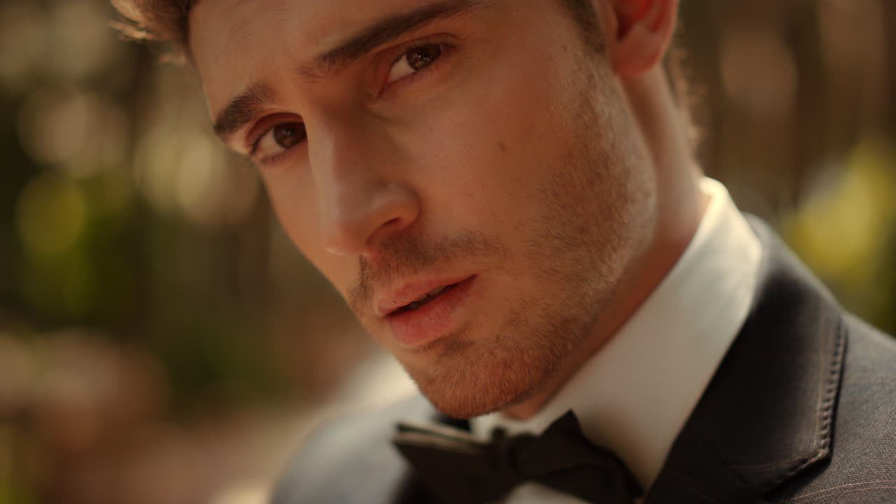 공원에서 생각하는 사려 깊은 남자. 긴장 신랑은 아치 아래 렌즈를 쳐다보고