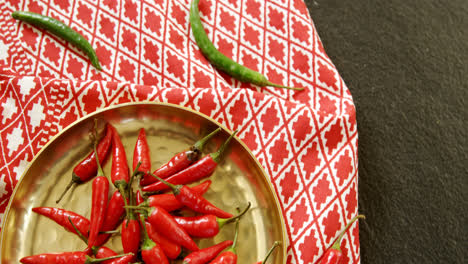 red chilies in plate on table cloth 4k