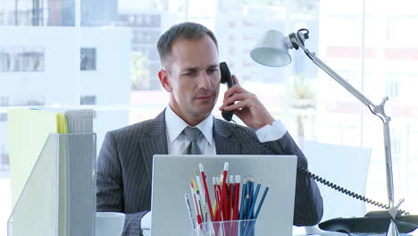 businessman working in office and talking on phone