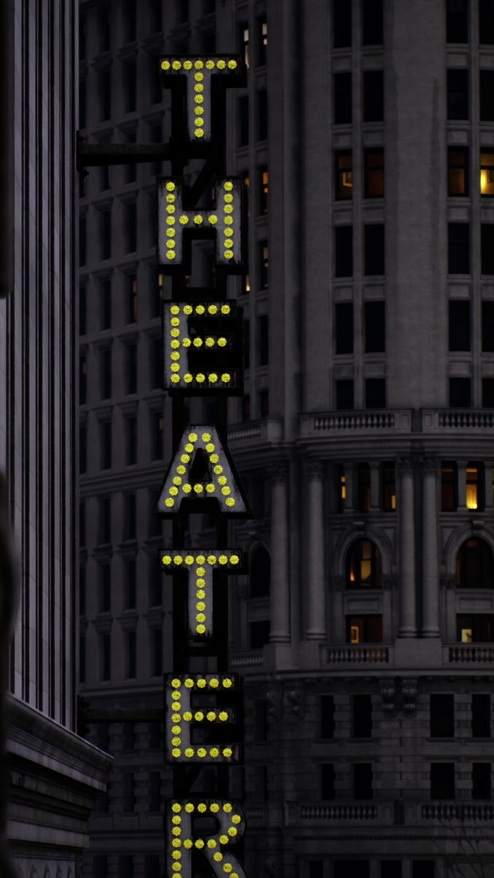 Bright lights shine on theater sign during evening in city center