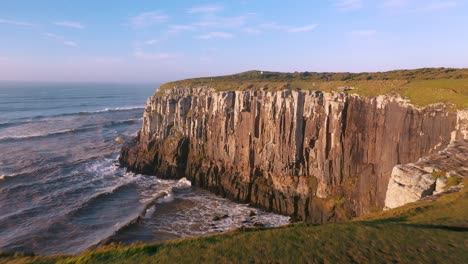 establishing beautiful aerial cinematic shot of cliffs on atlantic ocean