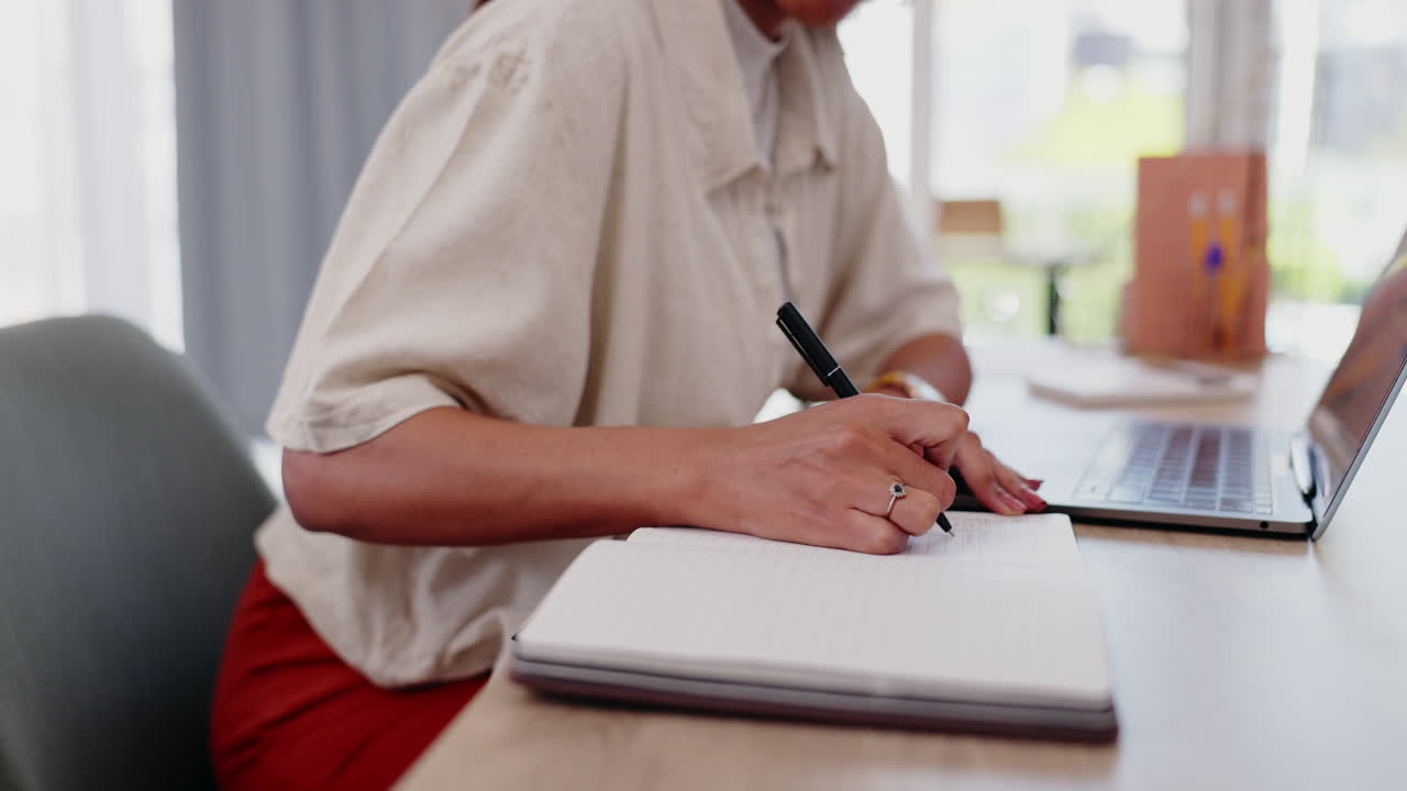 Woman working on laptop and notebook