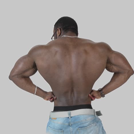back muscles of a black athlete. shirtless african american sportsman shows his trained body isolated on white. rear view
