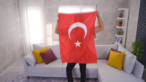 young rejoicing with turkish flag at home in slow motion.