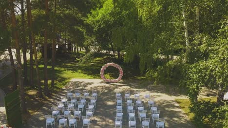 wedding venue with pink flower garland in park aerial view