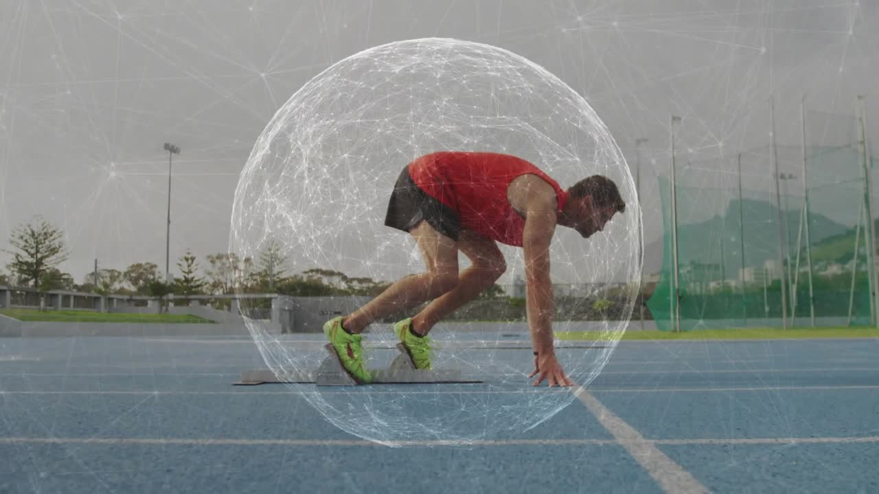 Male athlete pushing off mat, powering into sprint on blue training track, faint sphere overlaying