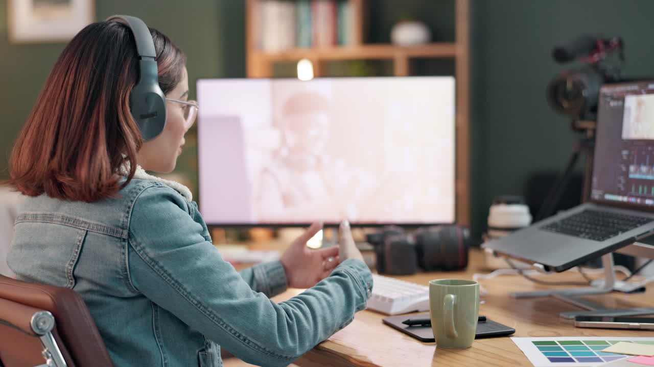 Woman video editor in a home office working on video footage