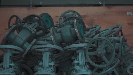 pile of valves in a wooden crate
