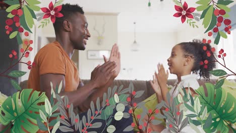 animation of flowers over happy african american father and daughter playing on sofa