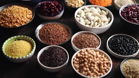 Various-superfoods-in-smal-bowls-on-dark-rusty-background