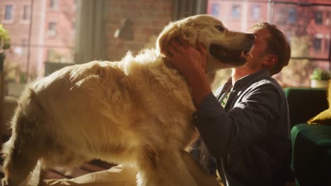 young adult man having fun and playing with his golden retriever pet on a living room floor. dog teasing and licking the face of the owner at home living room.