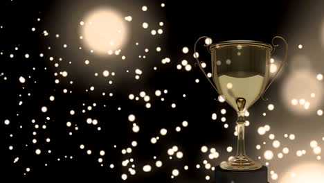 yellow glowing spots moving against golden trophy in background