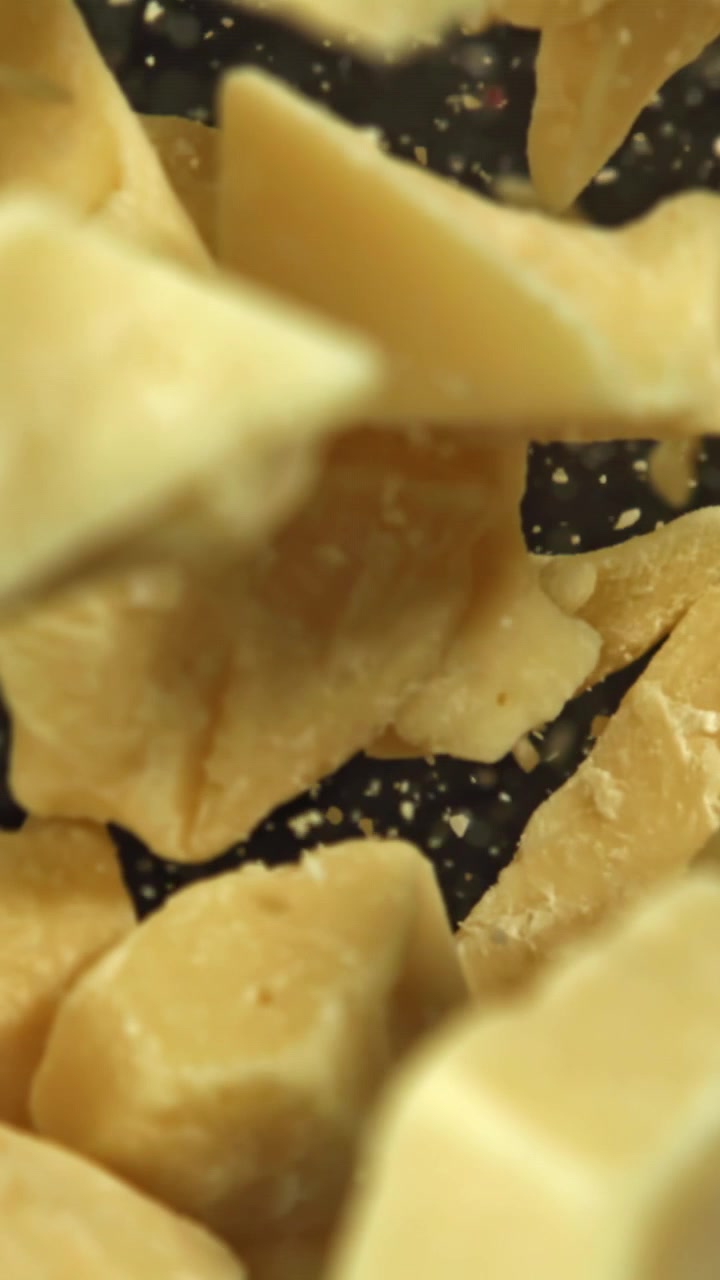 Cocoa Butter Chunks Floating in Slow Motion