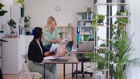 office workers discuss financial results and analyze documents