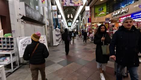 people walking through a busy shopping mall