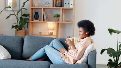 Relaxed-woman-listening-to-podcast-while-drinking