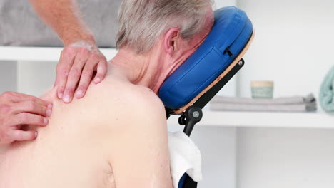 physiotherapist doing back massage to his patient