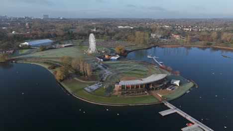 an aerial, early morning view of willen lake in milton keynes, showing the waterfront and observation wheel