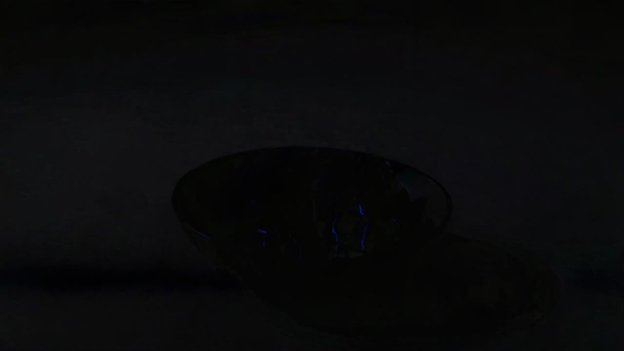 Dark Rocks in a Bowl with Glowing Cracks