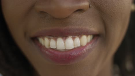 closeup shot of african american woman with toothy smile.