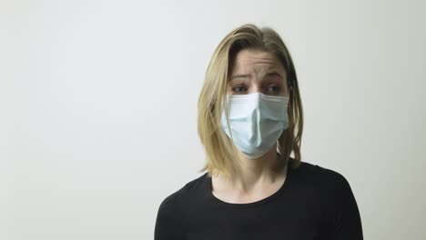 an excited woman tells a story with her face mask on