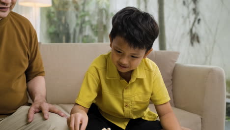 asian man and boy in the living room