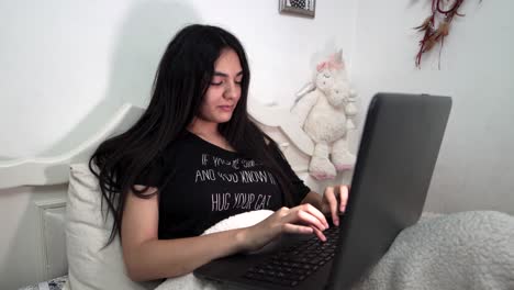 young girl writes on her computer