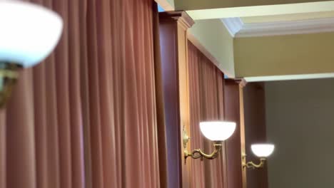 The-room-lights-are-on-with-decorative-curtains-on-the-walls