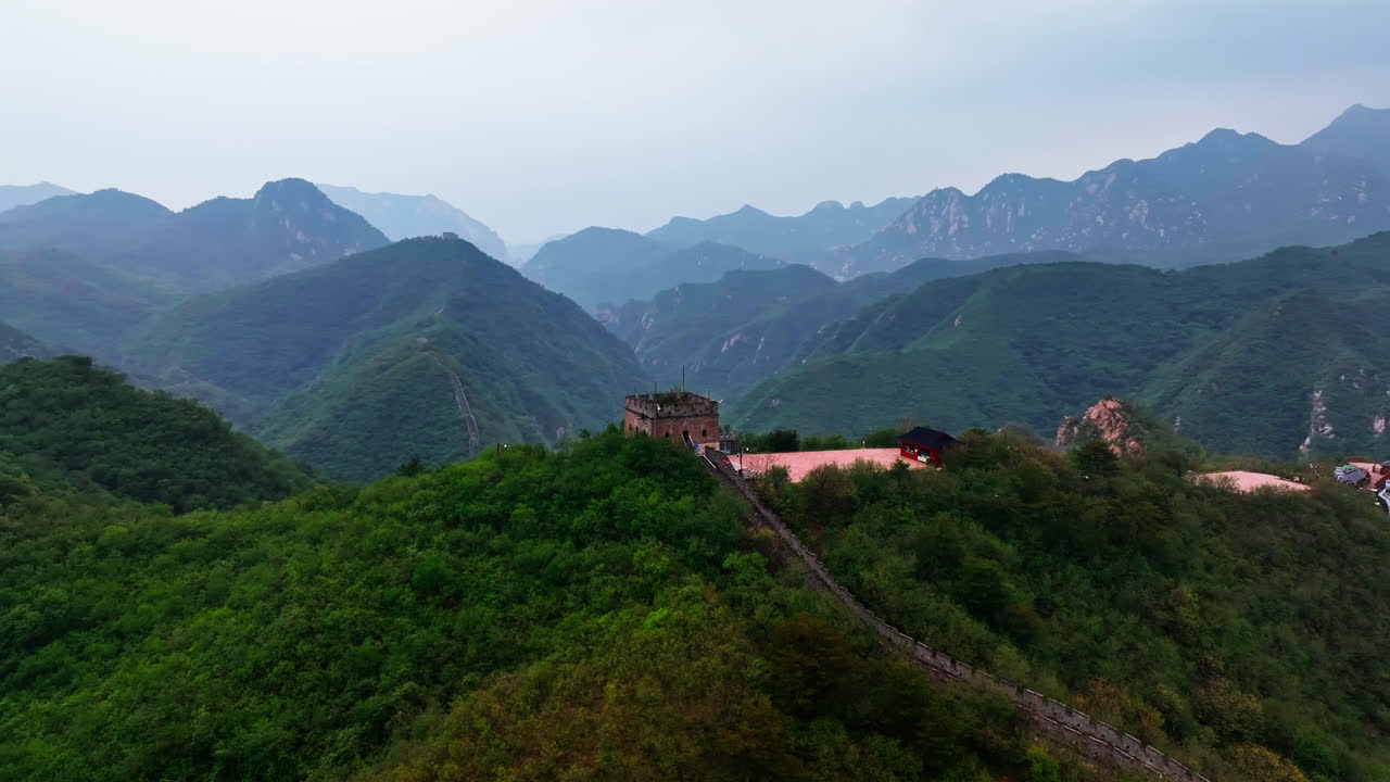 Aerial view orbiting a watchtower in the mountains of Great Wall, cloudy China