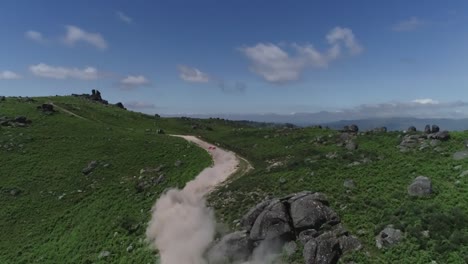 rally car going up a mountain ,shot by drone