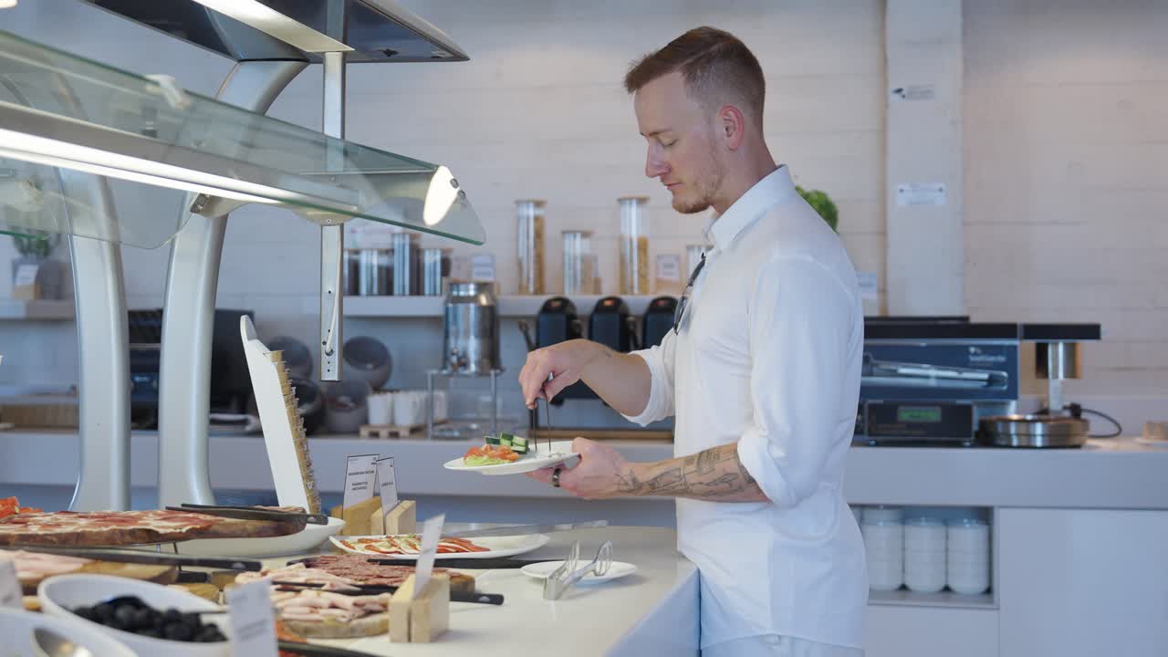Groom with white clothes eating breakfast before wedding, side view