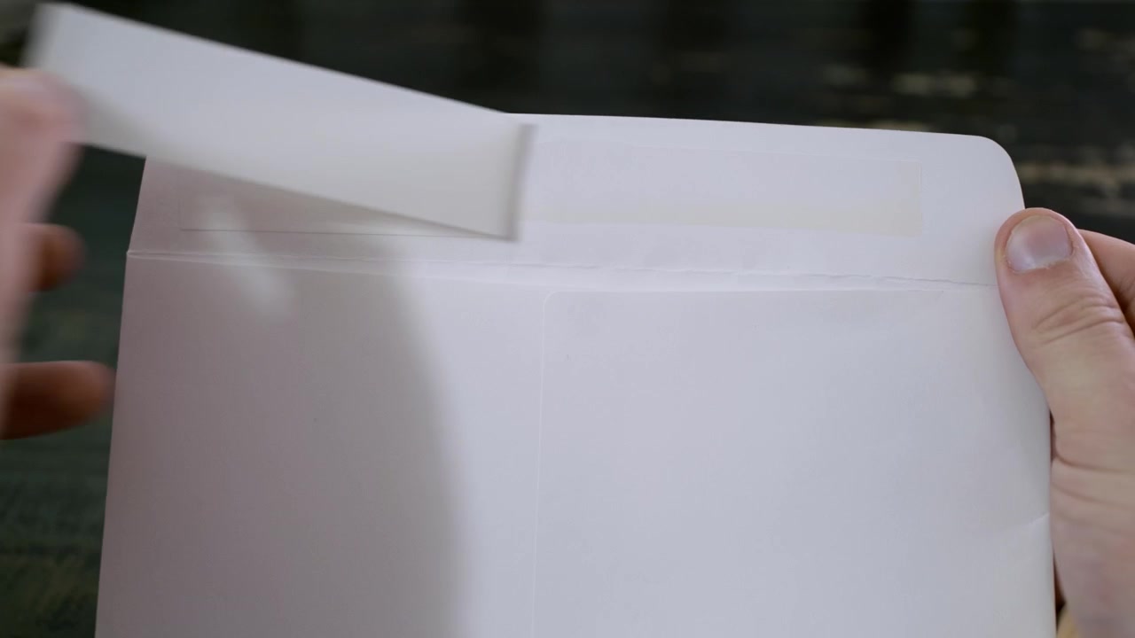 Closing an envelope, mail letter being closed up. Glue folding mail package, an envelope