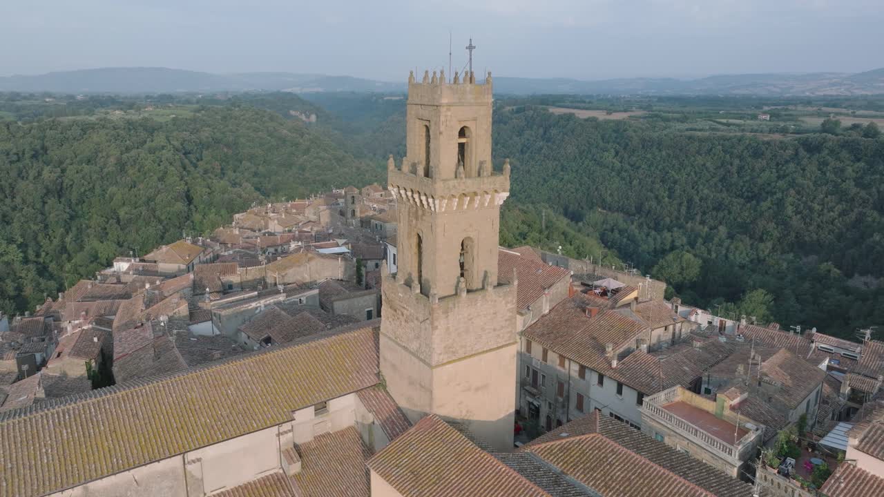 Aerial Drone view of the hilltop Medieval town of Pitigliano, Tuscany and the Valdorcia in morning light, flying over old buildings and rooftops, in 4K