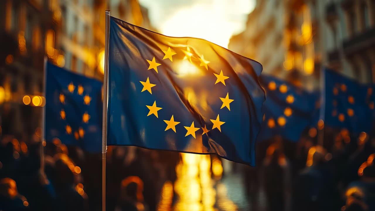 Crowd gathers under the European Union flag at sunset in a busy city street